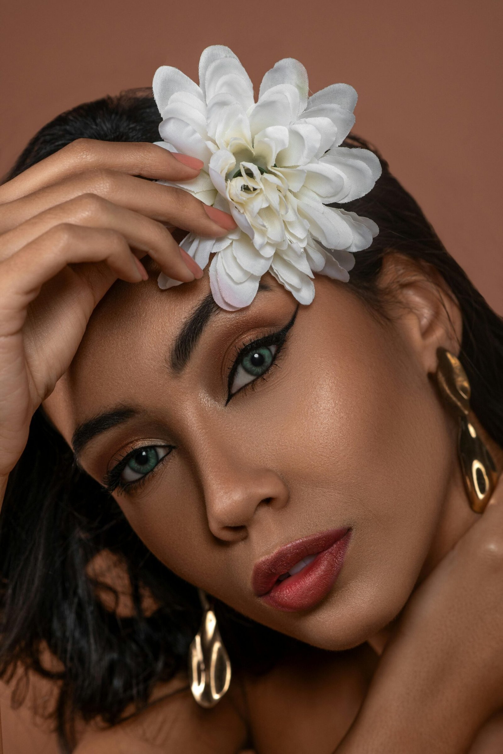 Woman with flower and earrings.